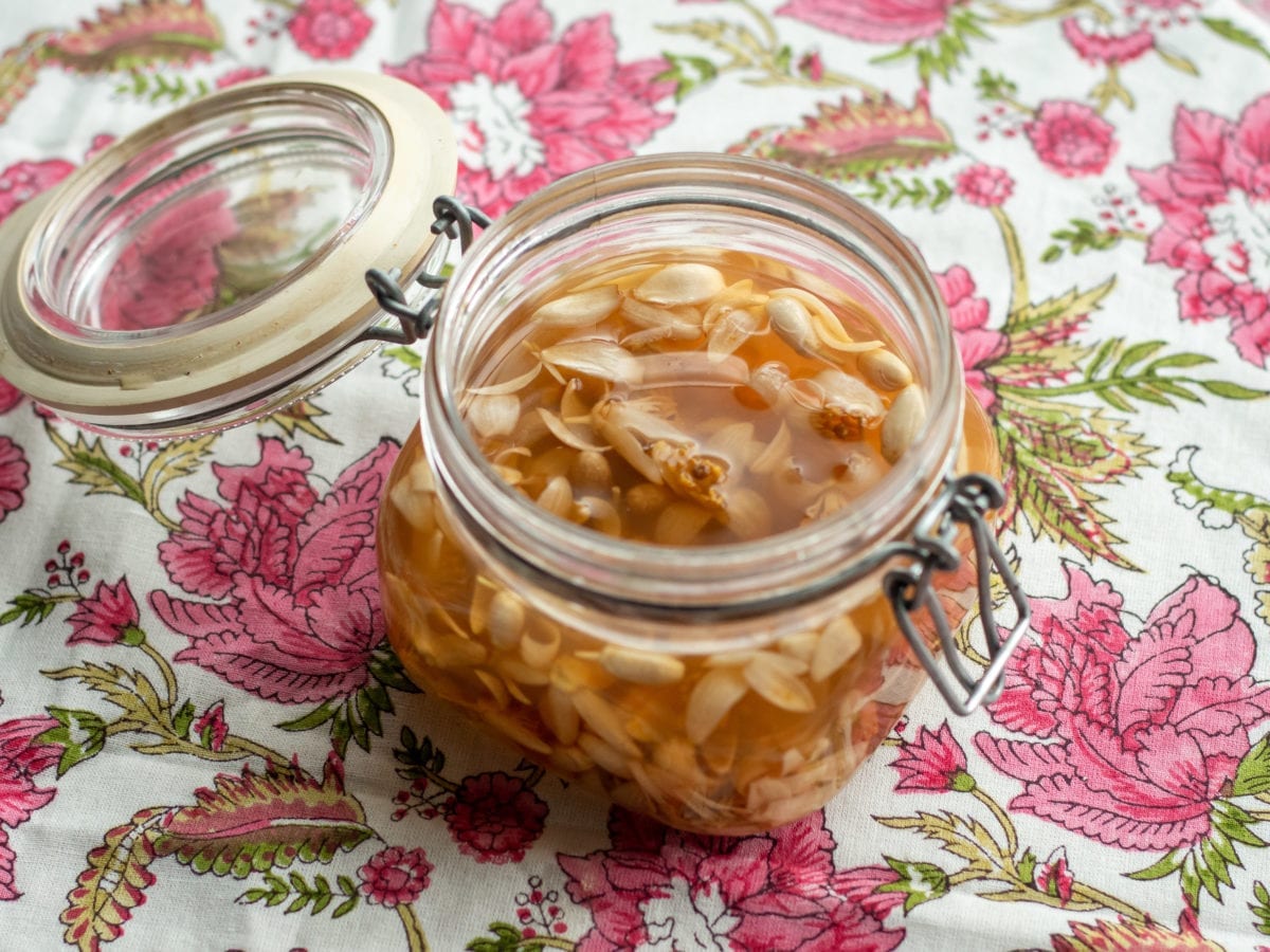 Preserved orange blossoms in vinegar in a glass jar