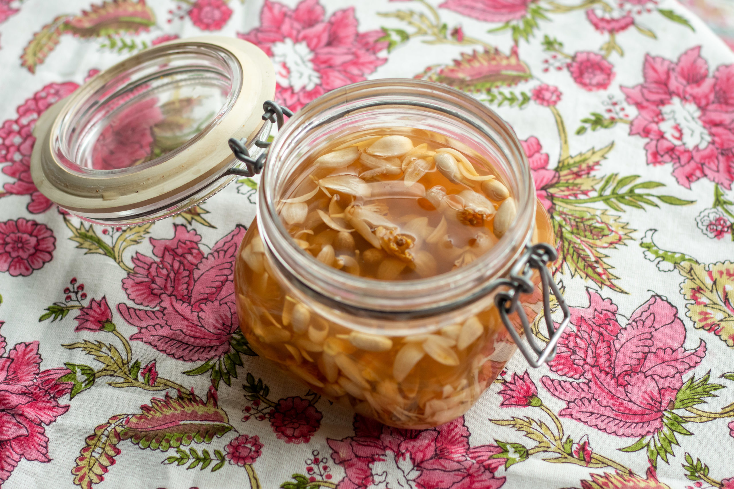 Preserved orange blossoms in vinegar in a glass jar