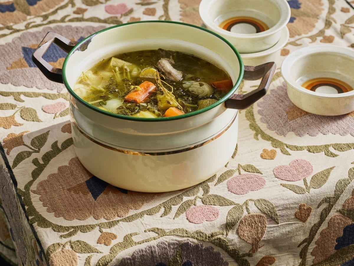 Nechama Rivlin's chicken soup in a cream colored crock pot