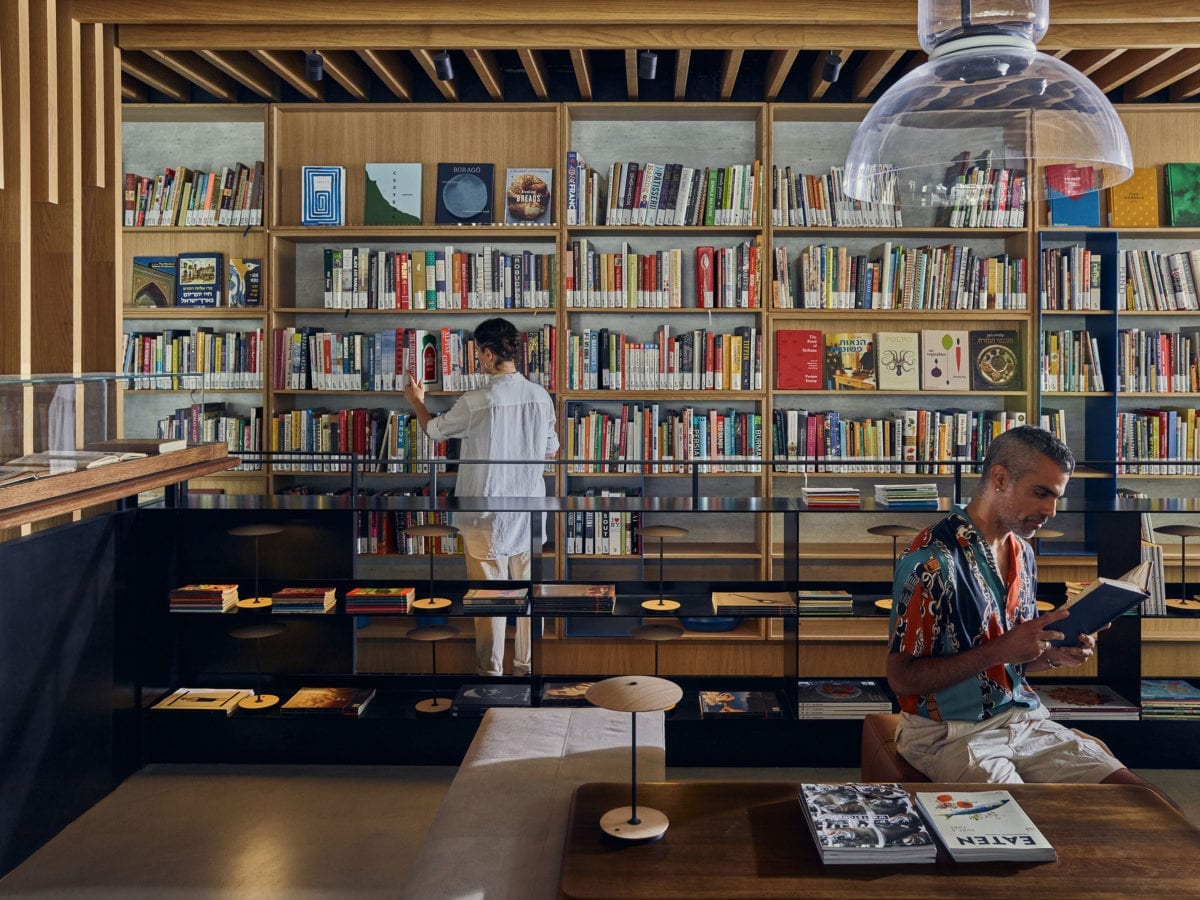 The Asif library with two people browsing the collection
