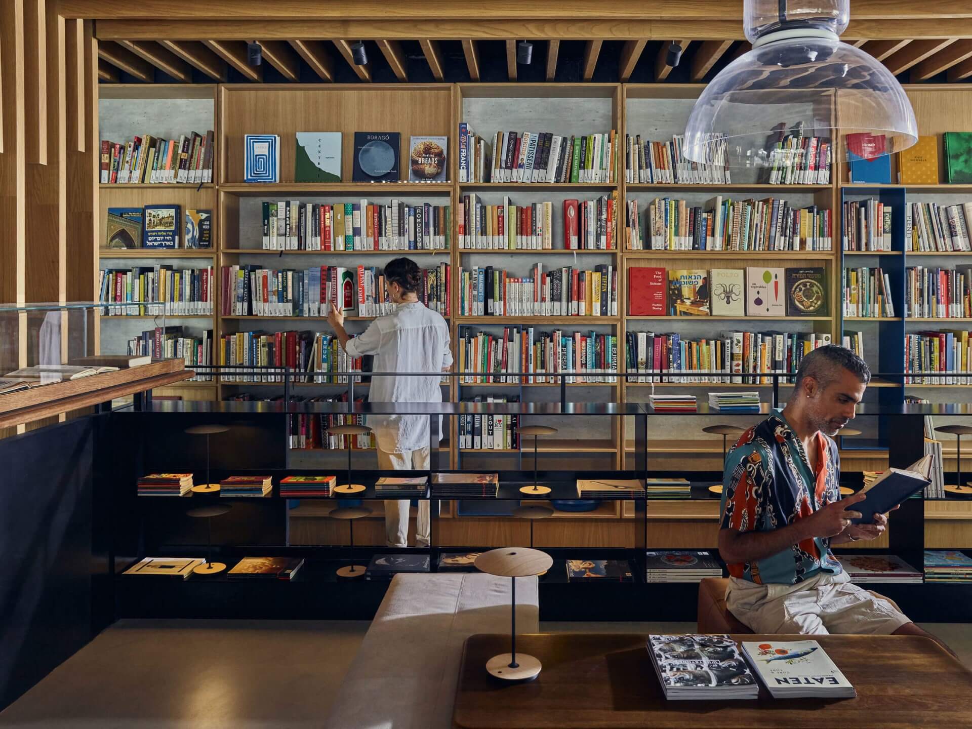 The Asif library with two people browsing the collection