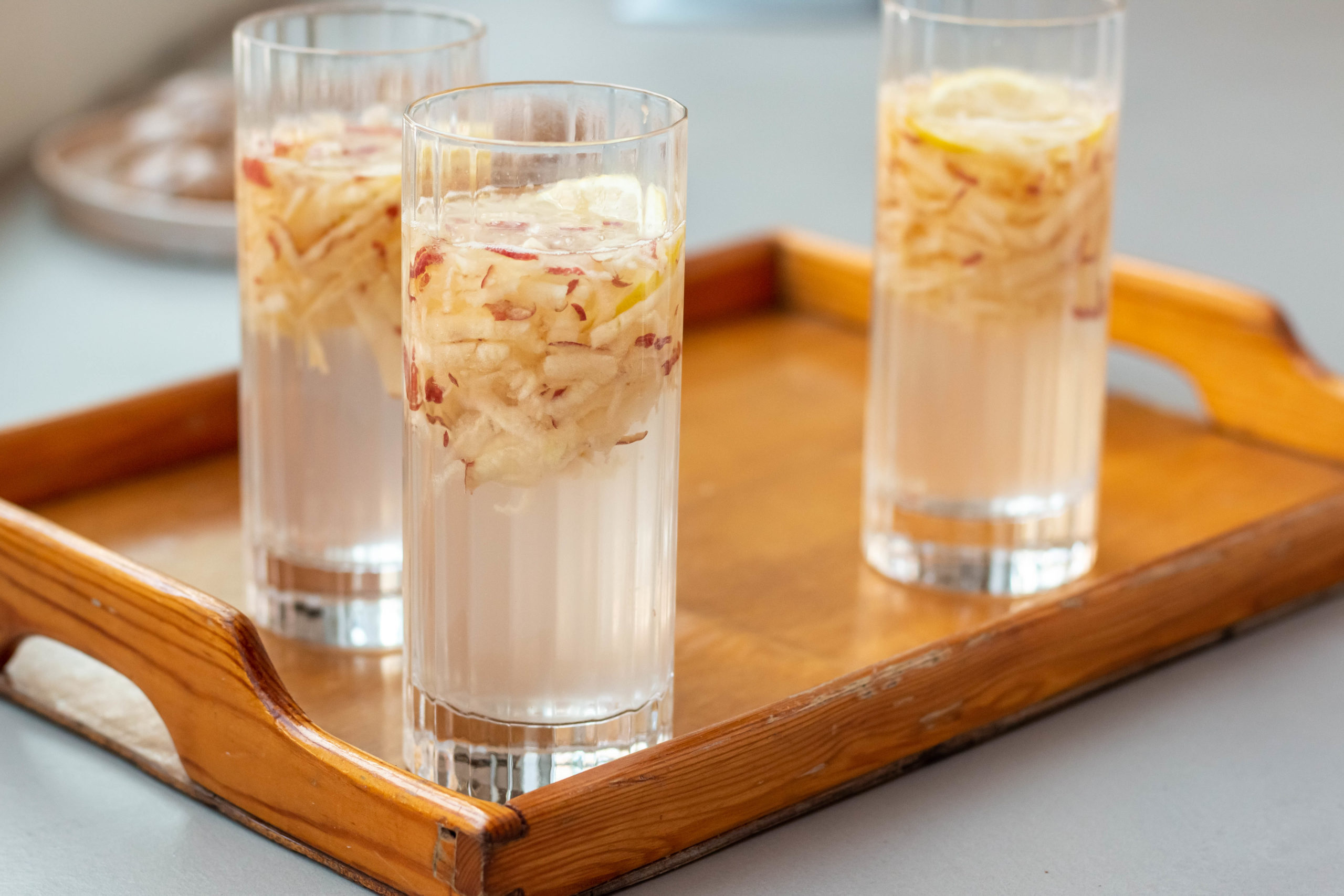 Glasses filled with apple sib faloodeh, a cold drink that can be enjoyed in the autumn.