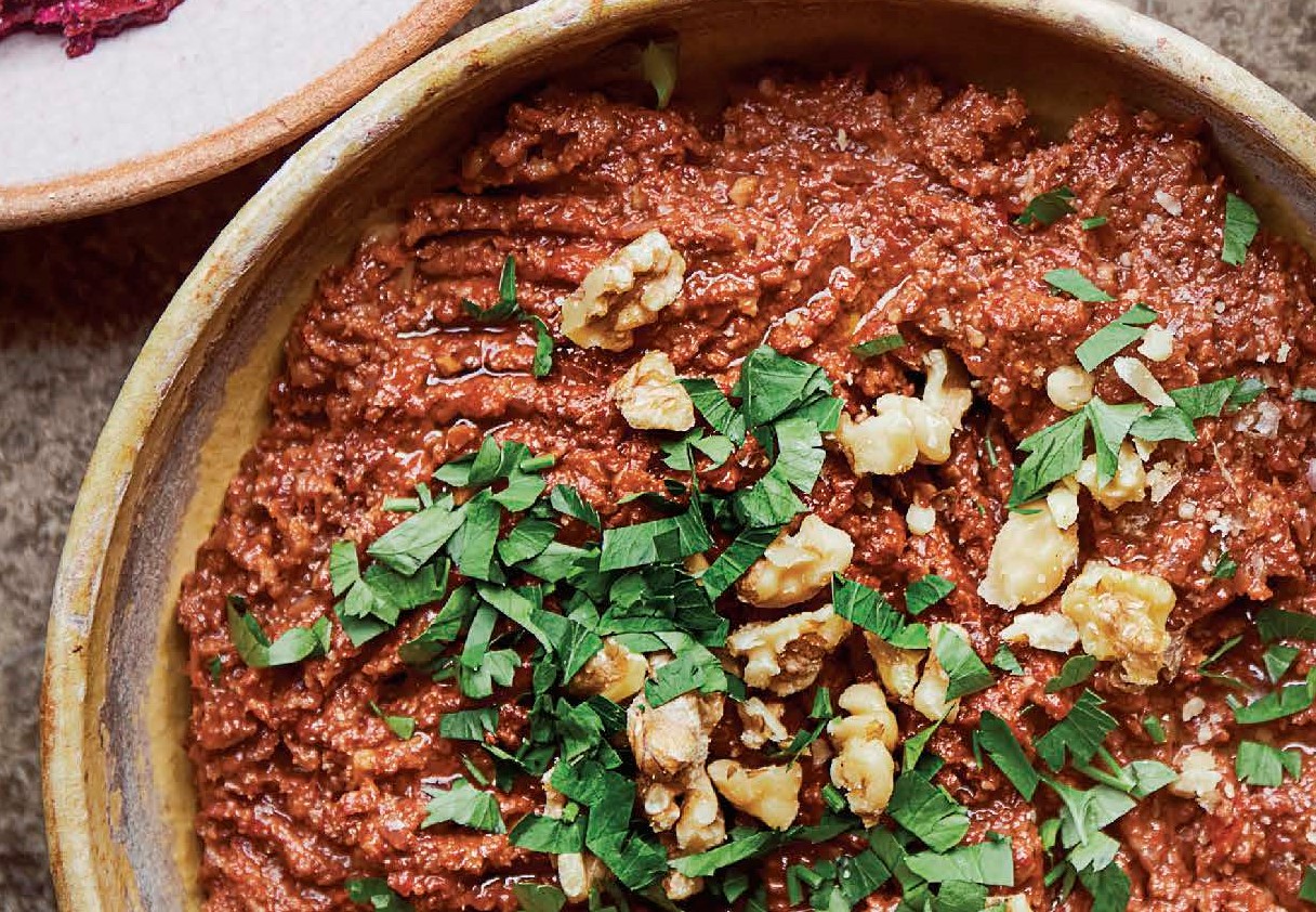 Muhammara, a Middle Eastern pepper spread topped with parsley and walnuts