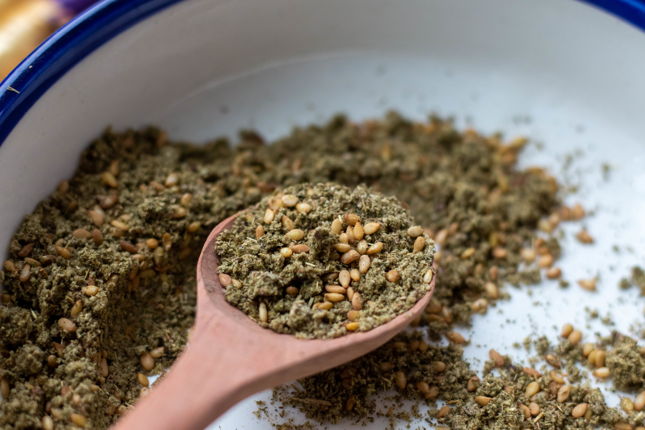 Wooden spoon holding za'atar spice blend