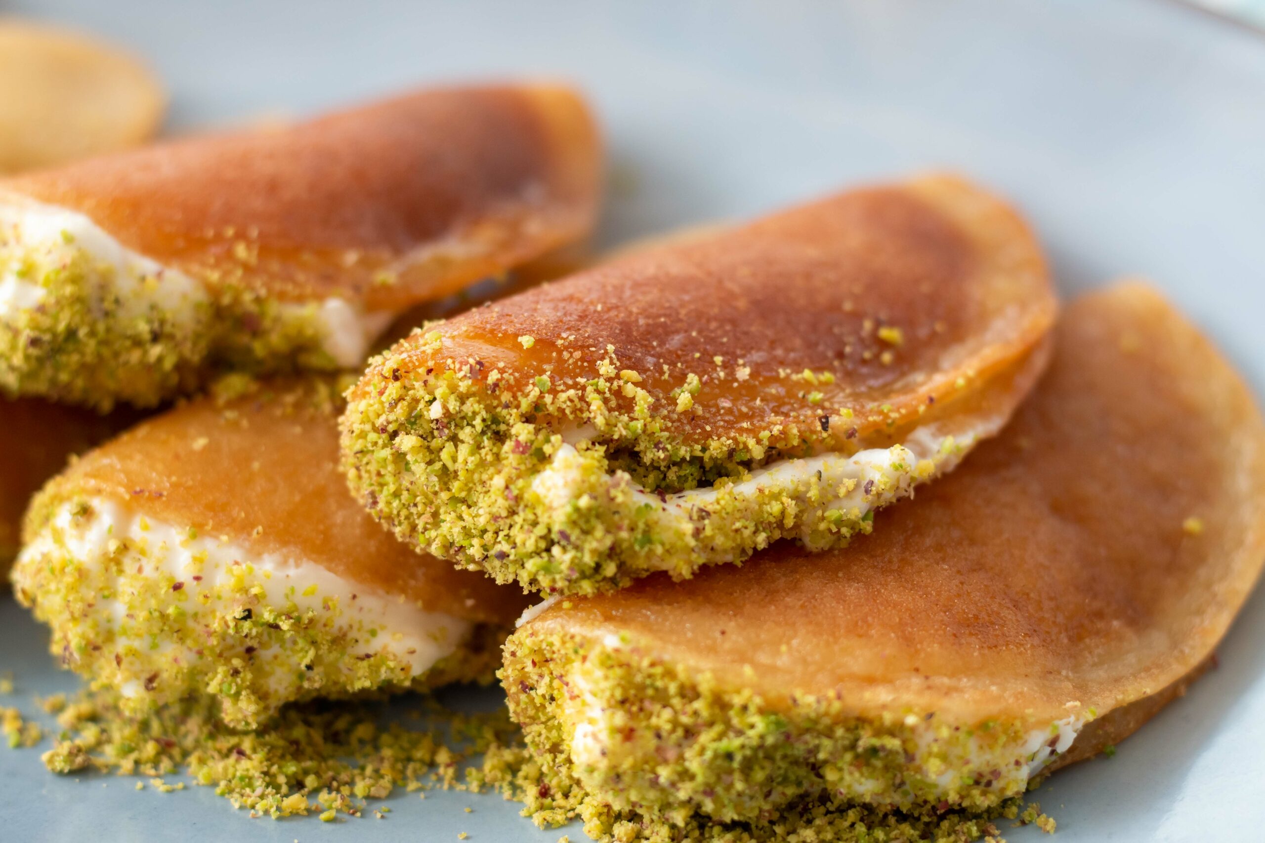 Small pancakes folded over cheese and finished with pistachios