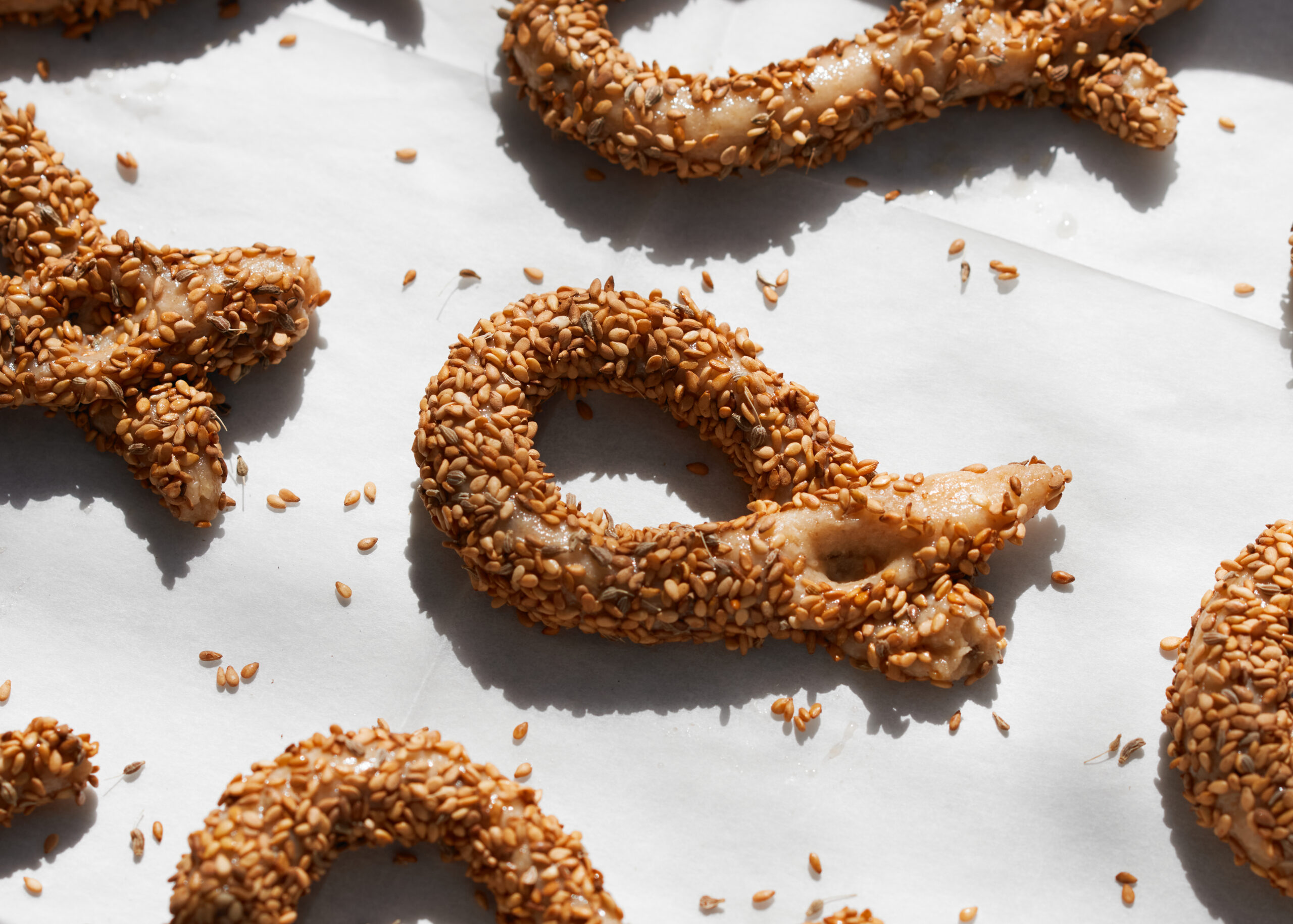 Ring-shaped sesame cookies on white background