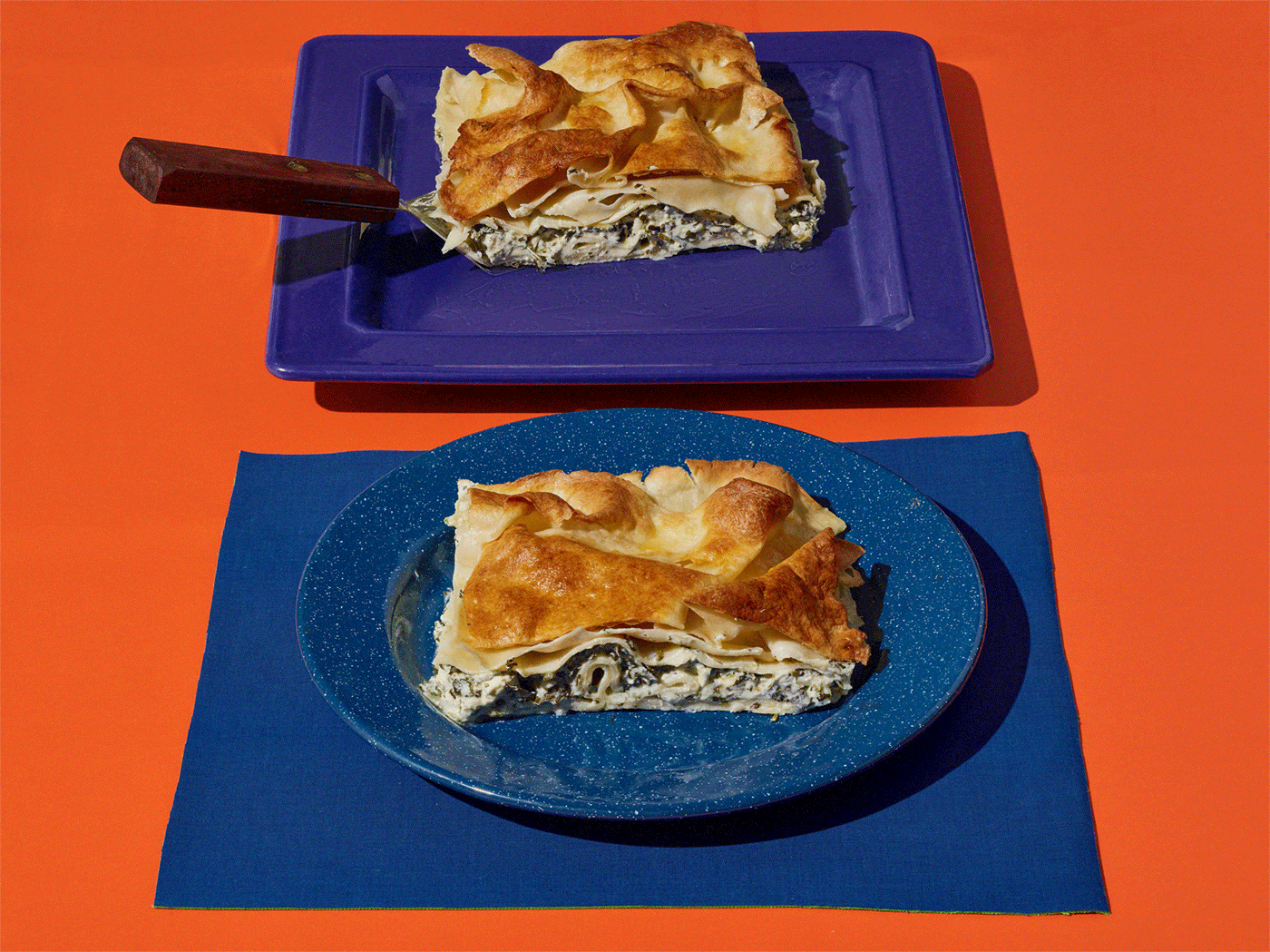 Slices of water borek on blue plates
