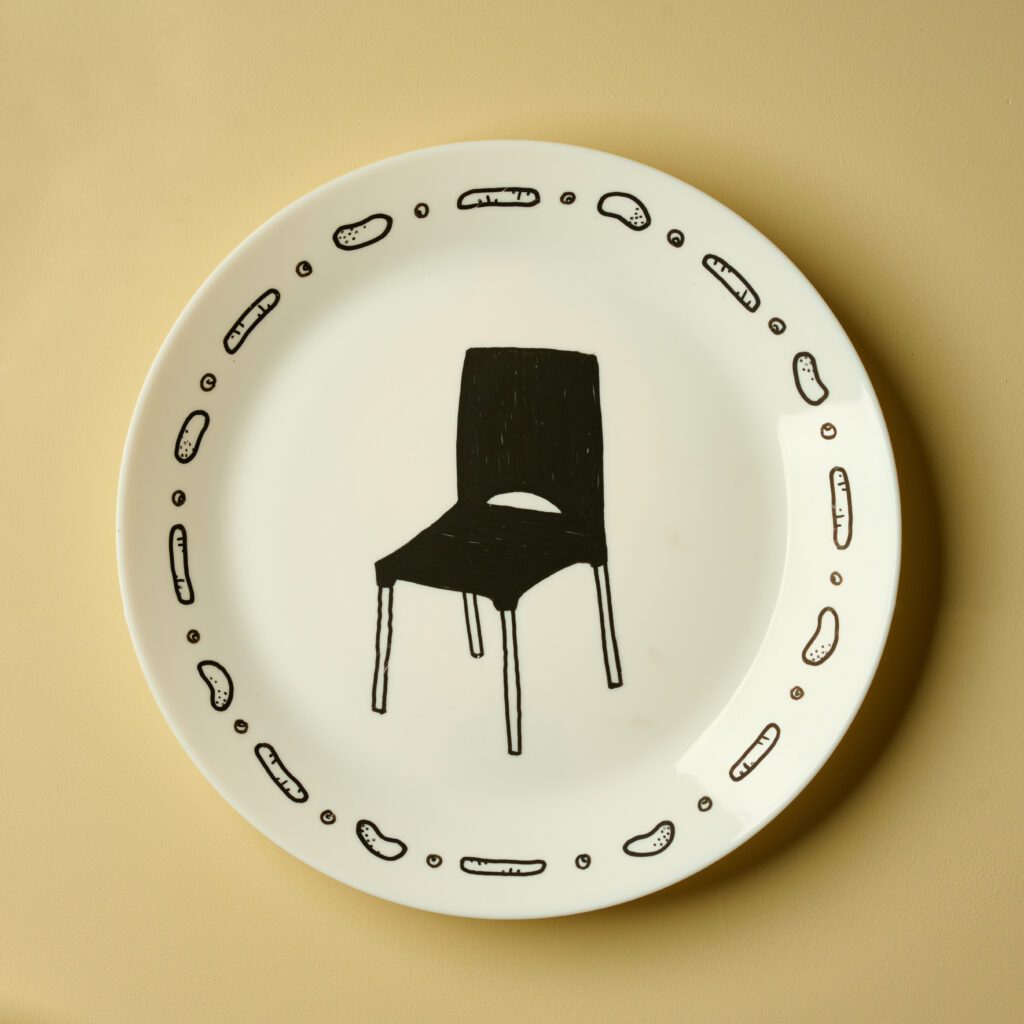 Cream plate with black chair design in the center