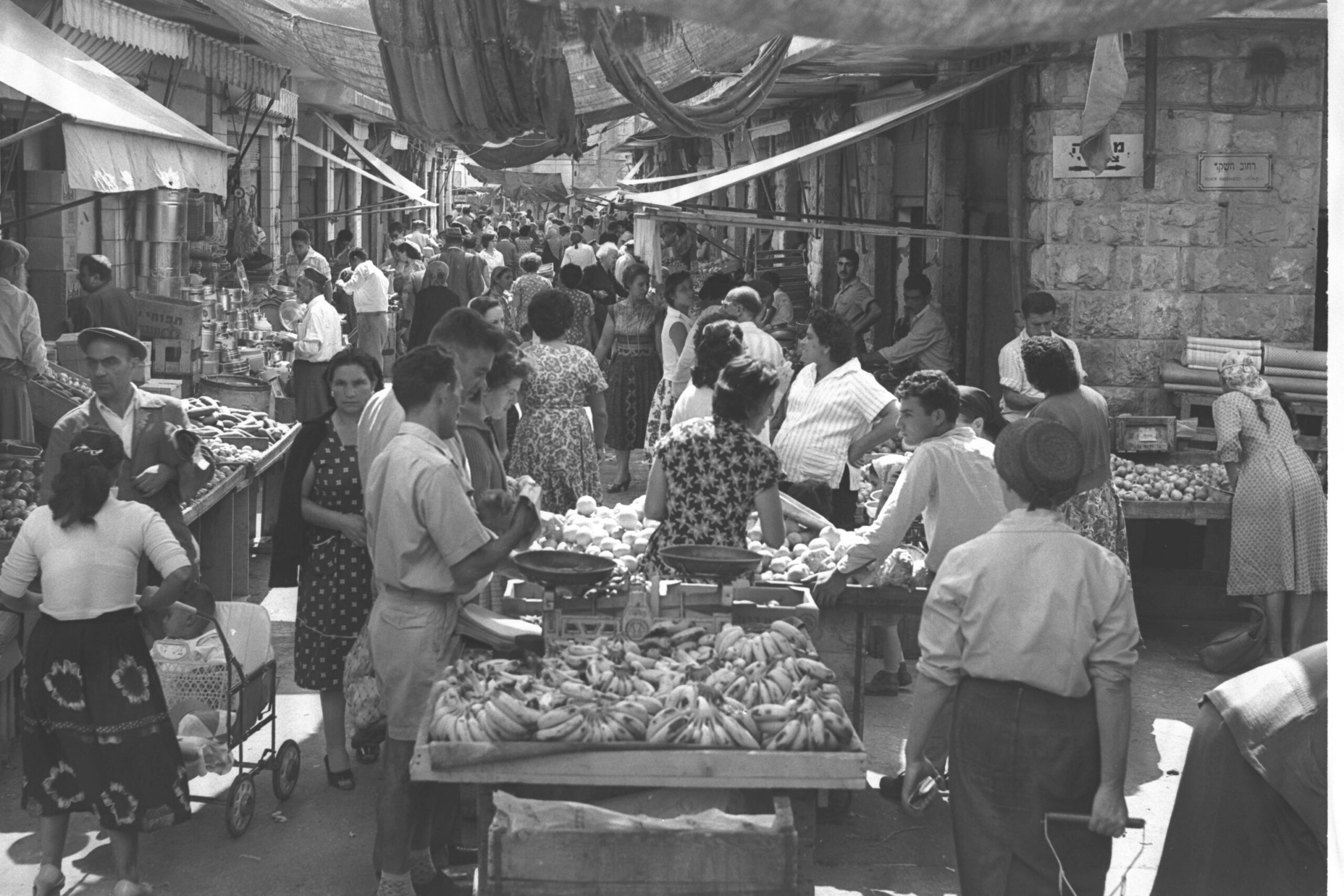 Jerusalem's machaneh yehudah market filled with shoppers in the 1960s