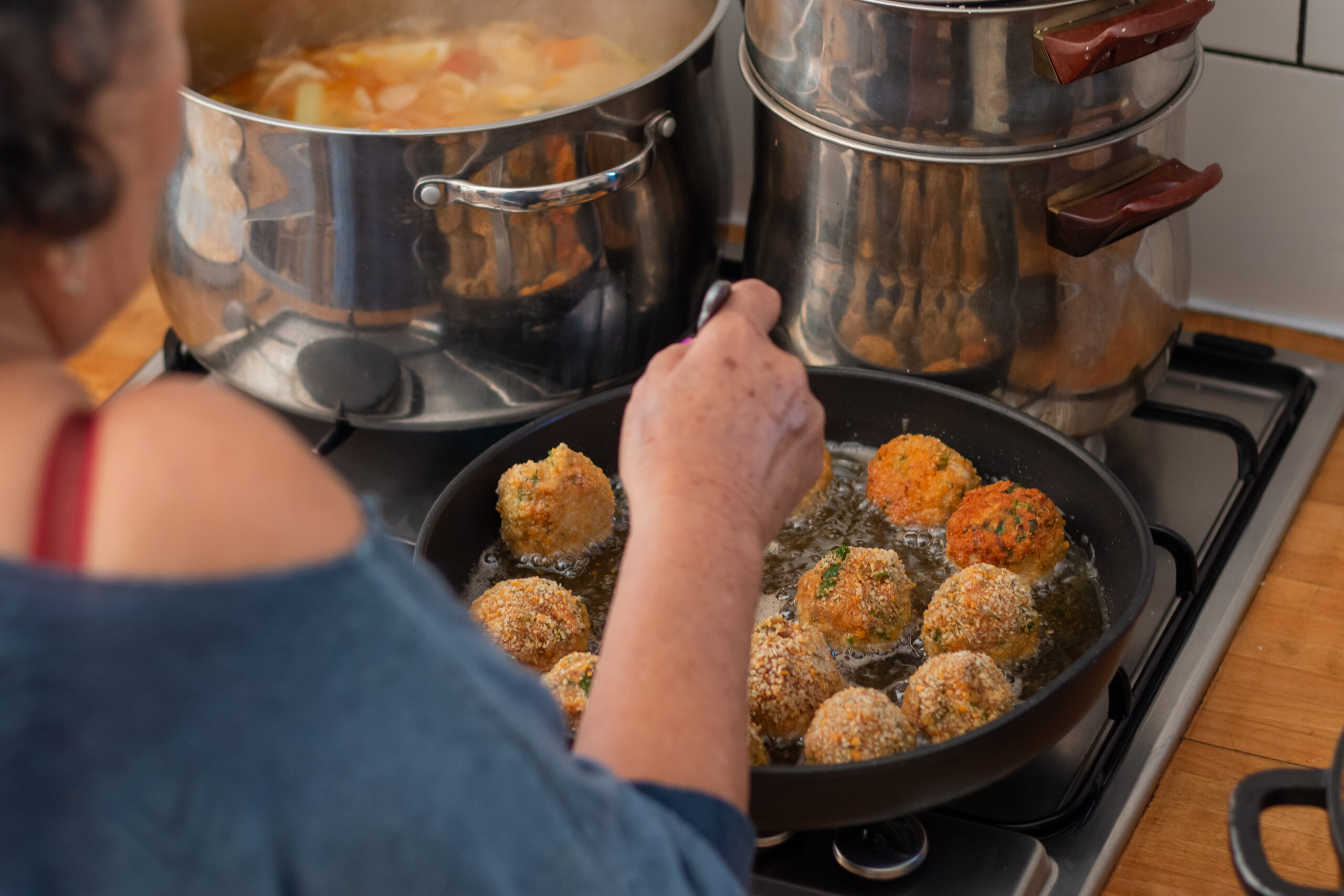 A woman tending to a frying pan