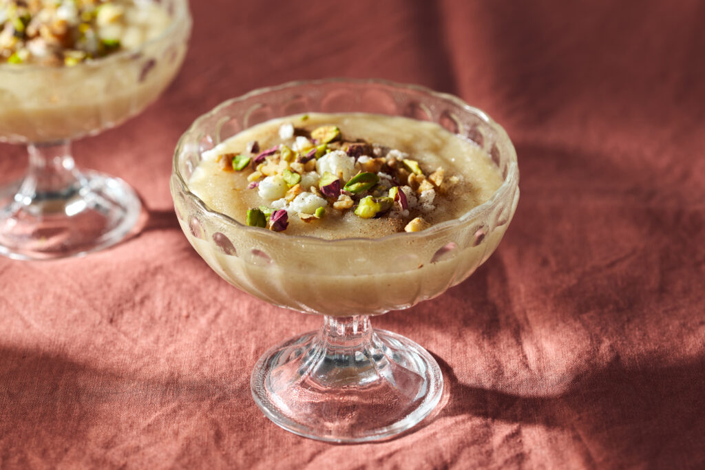 Mamounia (Syrian Semolina Pudding) with pistachios  on a pink tablecloth